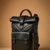Black leather roll-top backpack with matte hardware